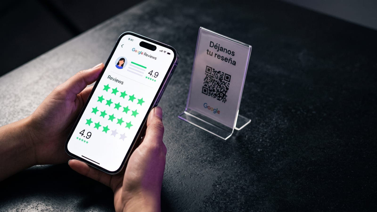 Cliente sosteniendo un smartphone con reseñas de Google de 4.9 estrellas frente a un exhibidor de acrílico con código QR que invita a dejar una reseña